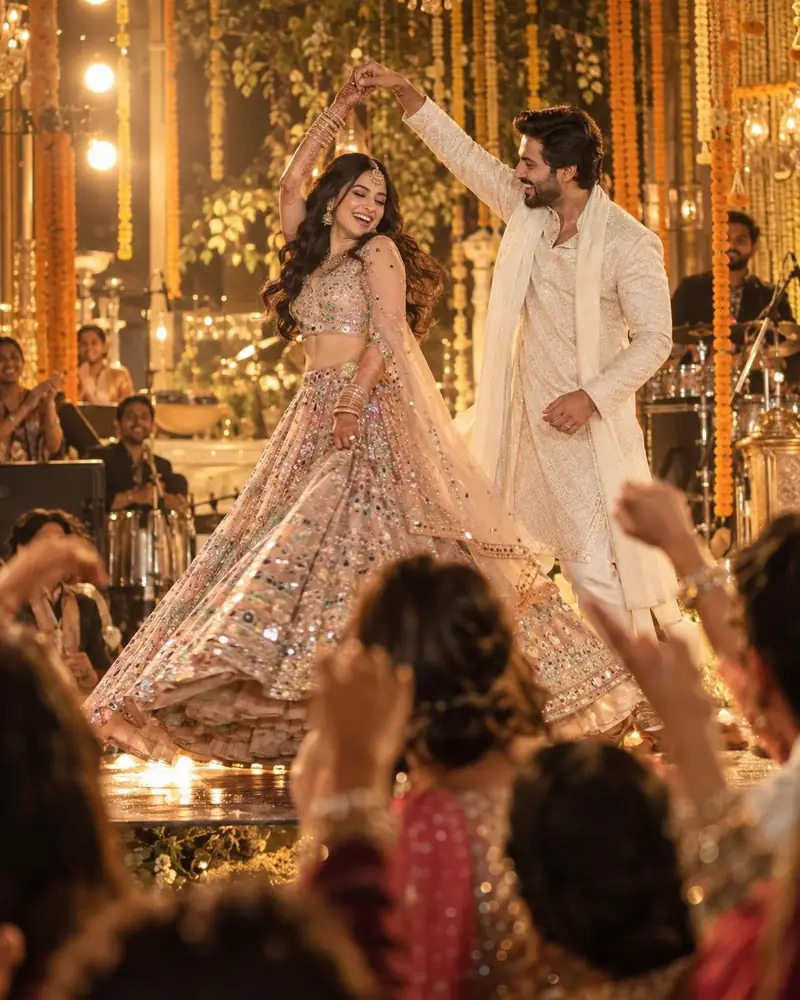 A bride and groom dancing on stage at their sangeet as relatives cheer