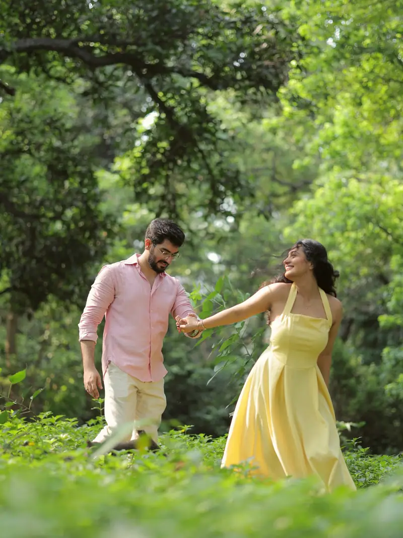 He leads her by the hand through the green garden