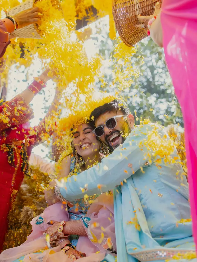 The couple hugging as yellow petals rain down on them