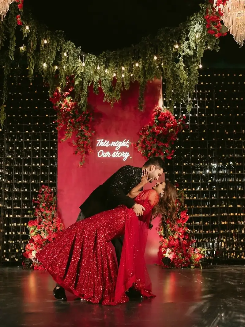 The groom dipping the bride at the end of their couple dance on stage