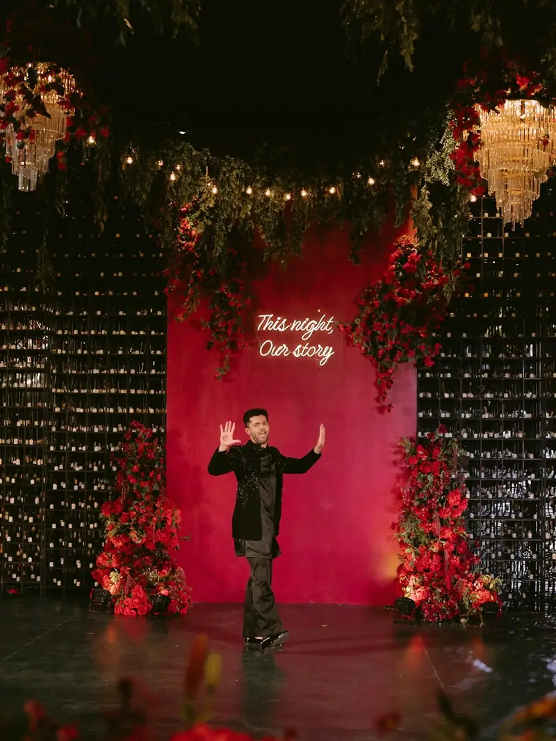 The groom dancing solo on the red sangeet stage