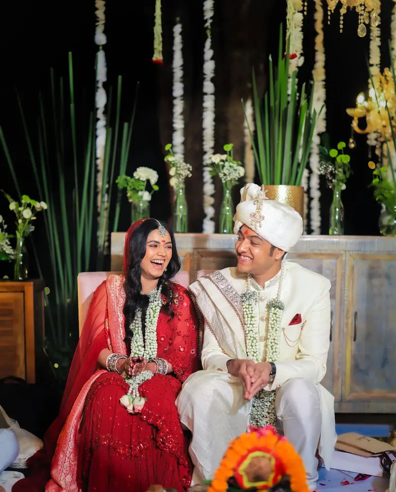 A bride and groom laughing together at the mandap
