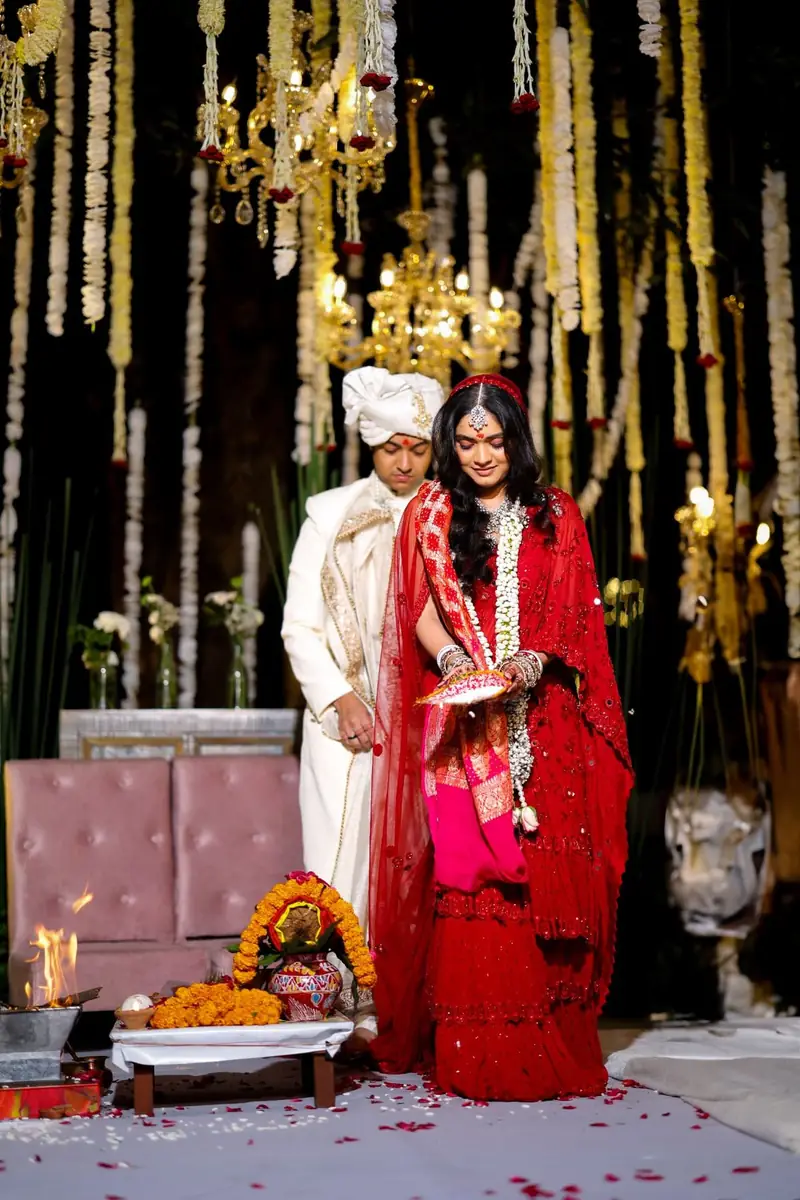 A bride and groom beside the sacred fire during the pheras